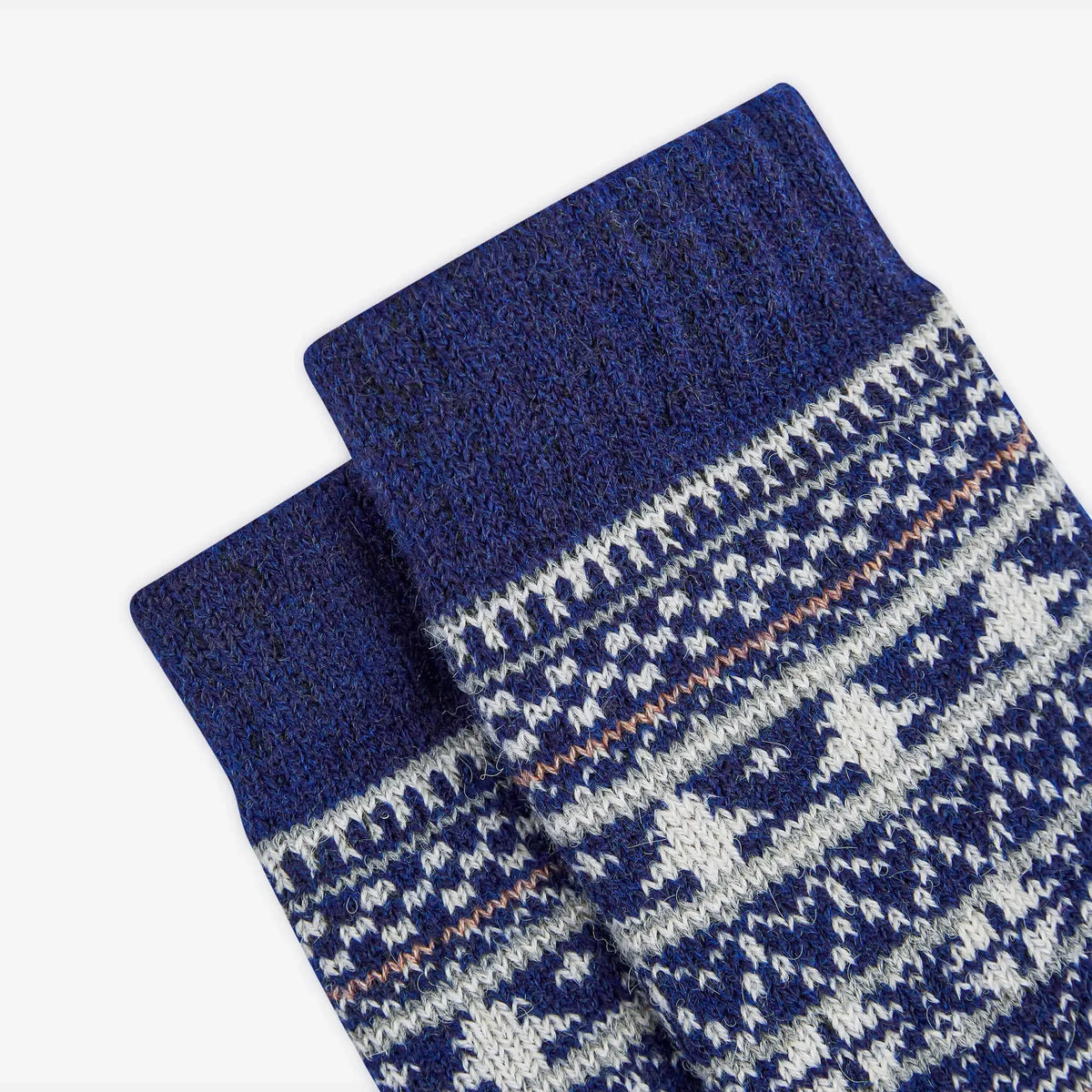 Pair of blue knitted socks with a pattern on a white background